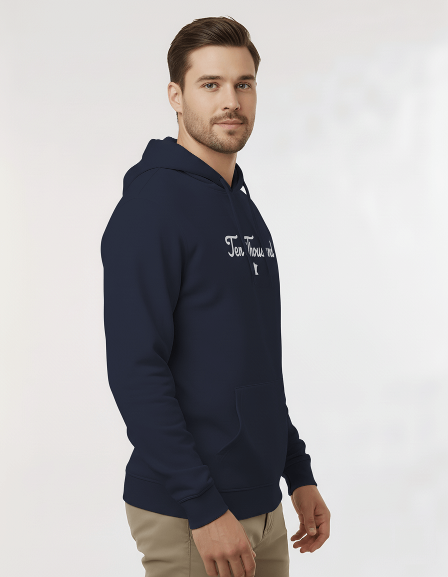 Man wearing a navy hoodie with a brand logo on a light gray background