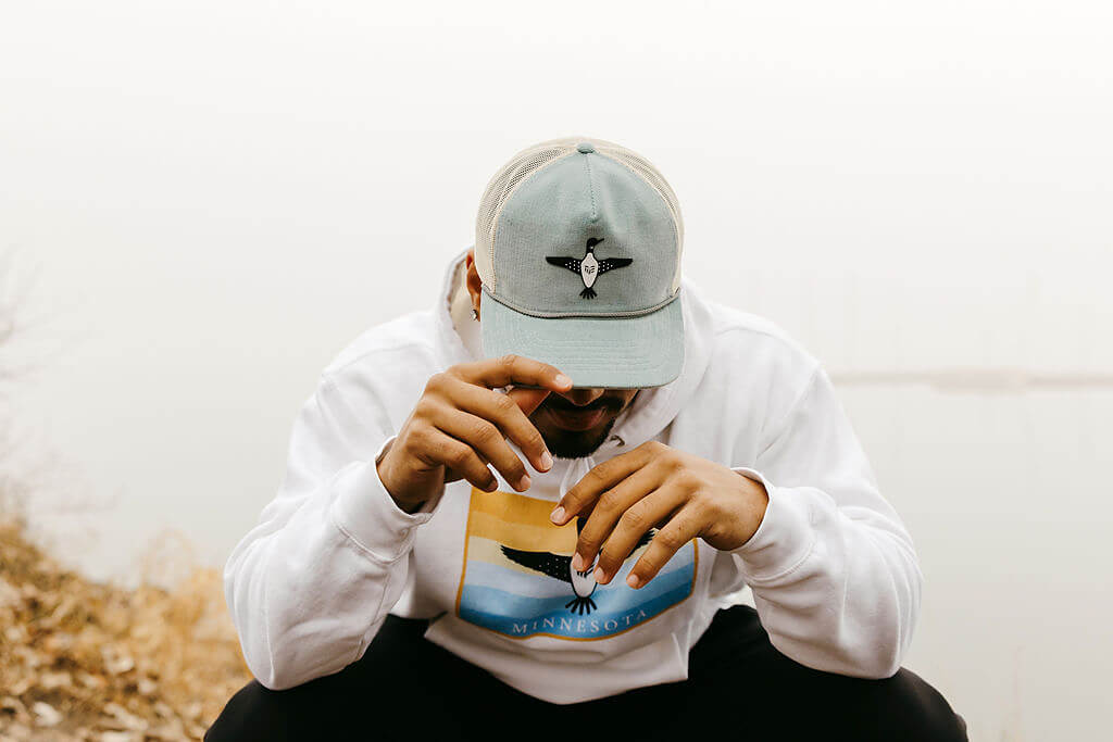 Modern Envy Apparel home page image with man in Loon corduroy hat