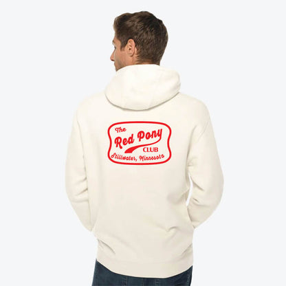 Person wearing a cream hoodie with 'Red Pony Club' logo on the back against a white background