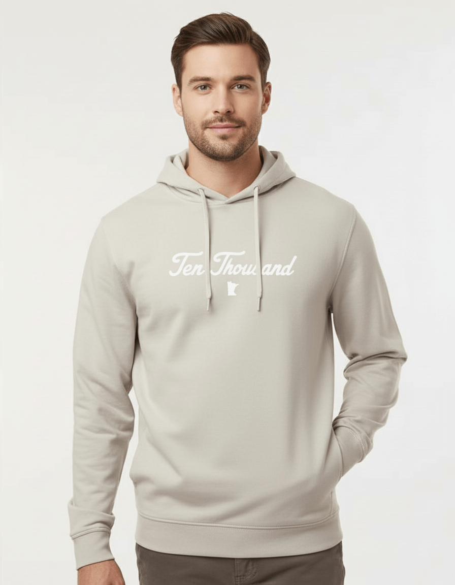 Man wearing a light gray hoodie with 'Ten Thousand' text on a white background
